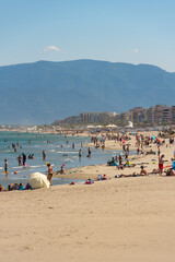 Obraz premium People in the beach. Sunny day in the tourist town of Canet en Roussillion in France on the Mediterranean Sea.