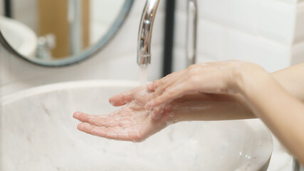 Obraz na płótnie Canvas Woman washing her hands, focus finger
