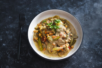 plant-based food, vegan chickpeas stew with carrots onion and broccoli in creamy dairy-free sauce