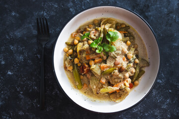 plant-based food, vegan chickpeas stew with carrots onion and broccoli in creamy dairy-free sauce