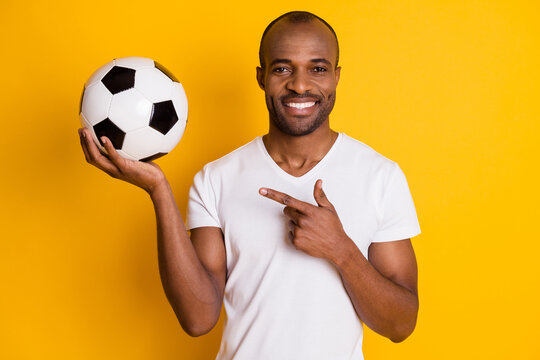 Portrait Of Positive Cheerful Afro American Guy Coach Teach Kids Play Football Point Index Finger Soccer Ball Wear Stylish Trendy Outfit Isolated Bright Shine Color Background