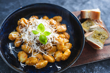 plant-based food, vegan red pesto gnocchi with dairy-free cheese topping