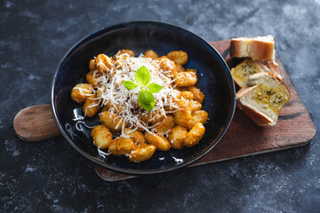 plant-based food, vegan red pesto gnocchi with dairy-free cheese topping