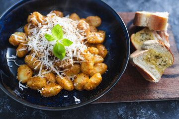 plant-based food, vegan red pesto gnocchi with dairy-free cheese topping