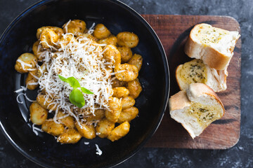 plant-based food, vegan red pesto gnocchi with dairy-free cheese topping