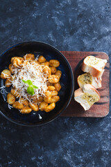 plant-based food, vegan red pesto gnocchi with dairy-free cheese topping