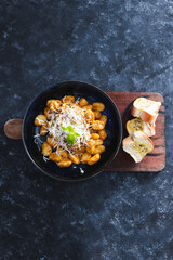 plant-based food, vegan red pesto gnocchi with dairy-free cheese topping