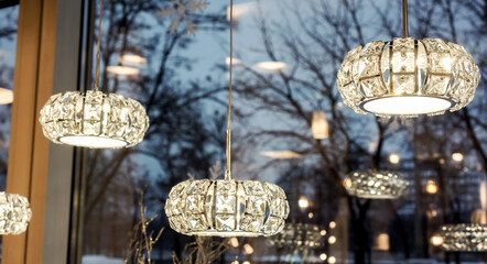 few luxury crystal round chandeliers in light shop