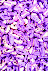 pattern of many white and violet tooth candies