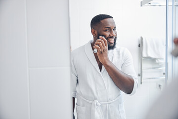 Positive delighted male person correcting his beard