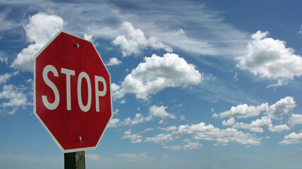 Stop sign and clouds