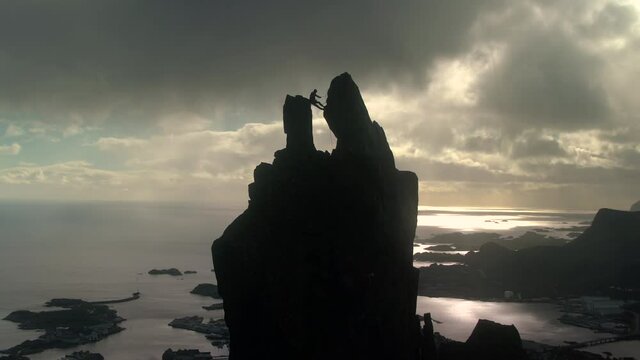 Rock Climbers climb The Svolvaer Goat, a 150 metre tall pinnacle overlooking the town of Svolvaer on the island of Austvagsoya, Lofoten, Nordland, Norway
