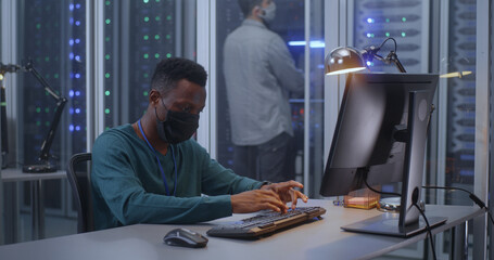 Fototapeta premium Young man working in data center