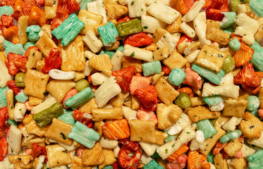 Background made of traditional colorful Tokyo mix or Japan mix. Japanese rice crackers backdrop. Top view.