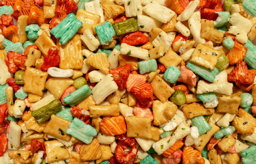 Background made of traditional colorful Tokyo mix or Japan mix. Japanese rice crackers backdrop....