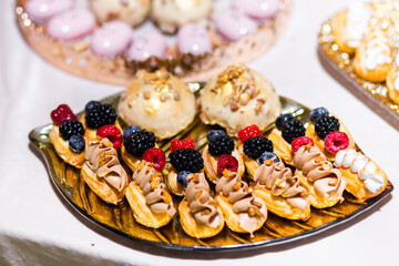 Delicious sweets on candy buffet. Candy bar on wedding ceremony with a lot of different candies.