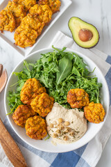 Healthy vegetarian buddha bowl with baked sweet potato, falafel