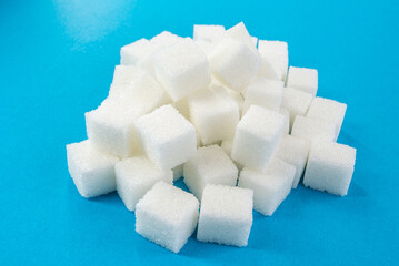 sugar cubes on a blue background. diabetes mellitus. Sweets. Strict diet