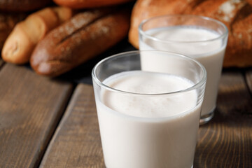 Probiotic cold fermented dairy drink kefir on wooden background.