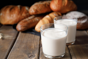 Probiotic cold fermented dairy drink kefir on wooden background.