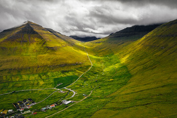 Eysturoy Island aerial panorama with green mountains and small village. Faroe Islands, Denmark.