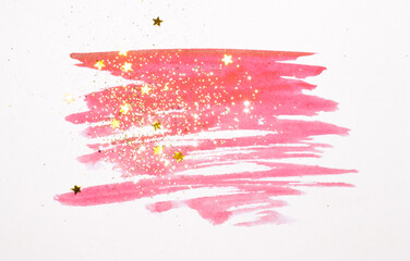 Golden glitter and glittering stars on abstract pink watercolor splash in vintage nostalgic colors on light gray background
