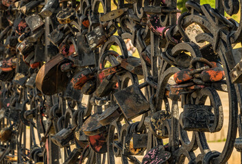 Old locks fastened on the fence for a love ritual. The ritual of the newlyweds