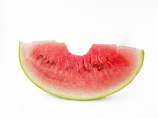 Juicy bright part of a red watermelon on a white background. A bit of watermelon. The trail from the teeth.