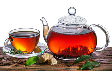 Tea ceremony. Glass teapot with brewed tea and a cup stands on an old table.