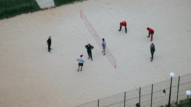People playing volleyball in a cort