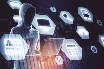 Hacker using laptop with glowing digital business interface