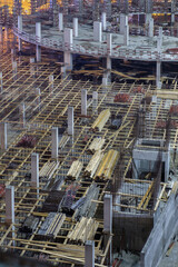 Stacs of deck at the empty illuminated construction site at night