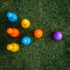 Children's set to play bowling on green grass. Ball and colored pins. Kid's game toy. Bowling colorful plastic pins. Active and interesting childhood concept.