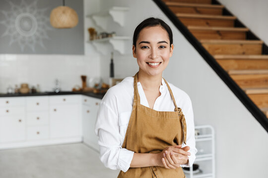 Smiling Attractive Young Asian Woman Wearing Apron