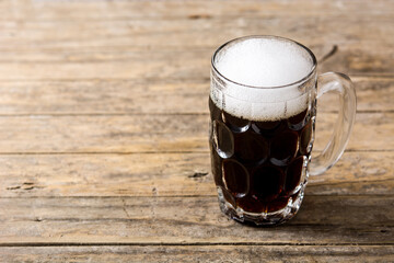 Traditional kvass beer mug on wooden table. Copy space	