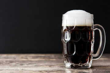 Traditional kvass beer mug on black background. Copy space	