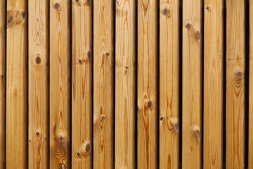 Brown wooden rough vertical planks with knots texture background