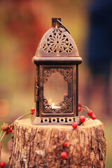 Retro lantern with a burning candle inside.
