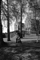 Old, but strong grandmother with her grandson playing by the seaside of the fjord of Norway, Oslo.