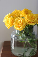 bouquet of yellow roses in a transparent vase