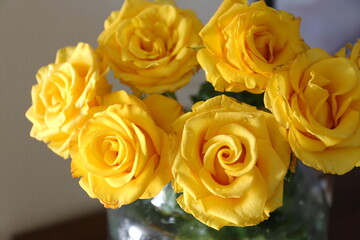 bouquet of yellow roses in a transparent vase