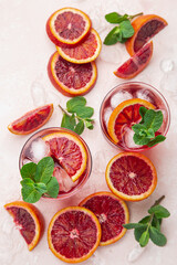 red blood orange cocktail with ice and fresh mint