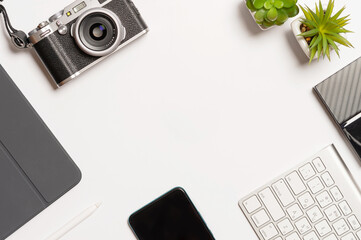 Frame with office equipment on white desk. Creative flat lay photo of workspace. 