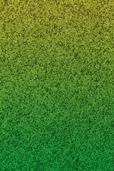 Green and yellow glitter textured paper closeup background