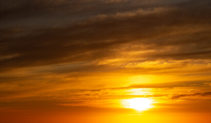 Naklejka na ściany i meble Dramatic golden sunset over the ocean.