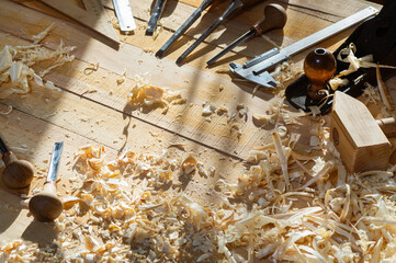 Carpentry concept. Joiner carpenter workplace. Construction tools on wooden table with shavings.