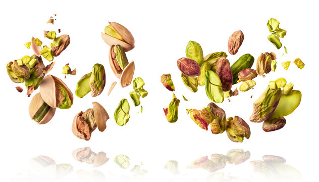 A set with Flying in air fresh raw whole and cracked pistachios  isolated on white background. Concept of Pistachios is torn to pieces close-up. High resolution image