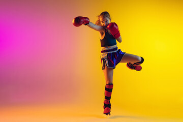 Fototapeta na wymiar Little caucasian girl, kick boxer on gradient background in neon light, active and expressive. Concept of motion, action, motivation, childhood. Training winner, emotional. Sales, ad, copyspace.