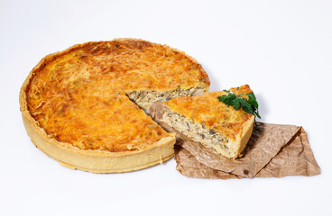 Delicious baked pie with meat, mushrooms, cheese and herbs on a white background.