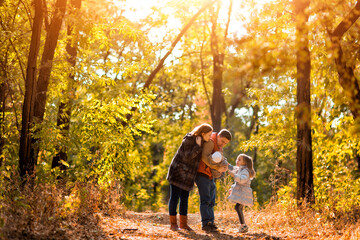 Fototapeta premium family with children walking in autumn Park. walks in nature